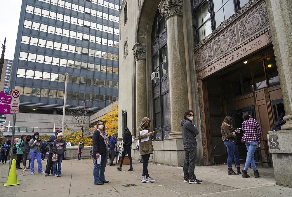People wait in line to apply for mail-in or absentee ballots at the County Office Building Tuesday, Oct. 27, 2020, in Pittsburgh. (Steve Mellon/Pittsburgh Post-Gazette via AP)