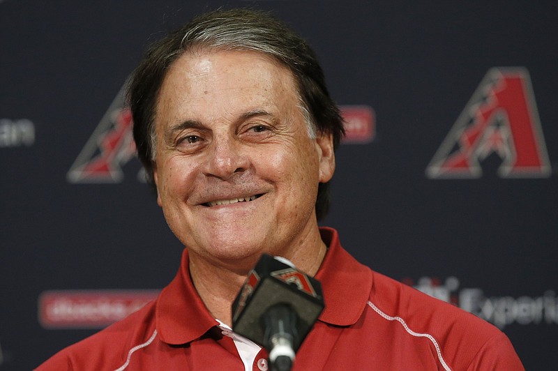 FILE - In this July 22, 2014, file photo, Arizona Diamondbacks Chief Baseball Officer Tony La Russa smiles as he talks about his upcoming induction ceremony into the Baseball Hall of Fame during a news conference in Phoenix. La Russa, the Hall of Famer who won a World Series championship with the Oakland Athletics and two more with the St. Louis Cardinals, is returning to manage the Chicago White Sox 34 years after they fired him, the team announced Thursday, Oct. 29, 2020. (AP Photo/File)