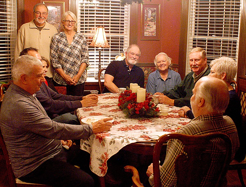 Westside Eagle Observer/RANDY MOLL
Ric and Debbie Stripling (standing) host a gathering of the Siloam Springs Civitan Club in their home on Thursday evening. The Striplings purchased the former Apple Crest Inn in Gentry as their retirment home so that they can also have room to provide care for four people with disabilities.