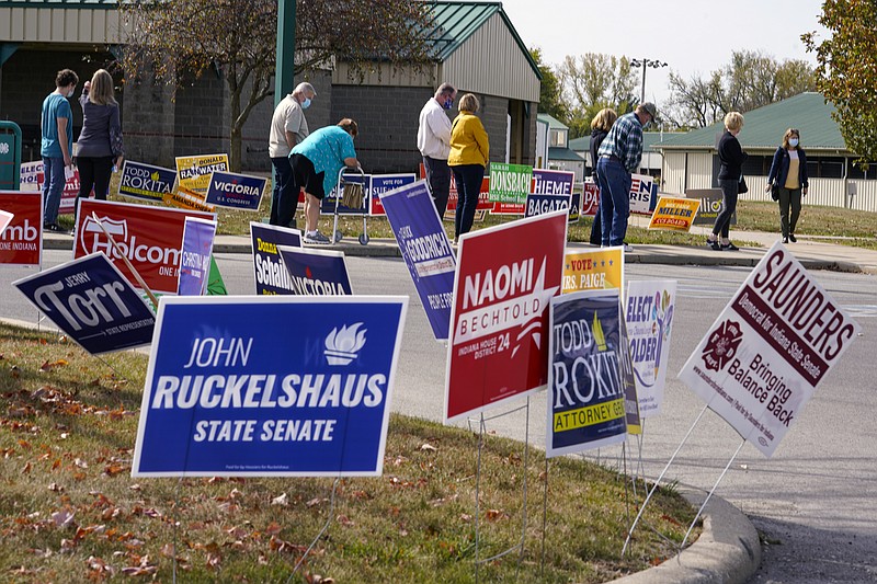 Voters wait in line to cast their ballot in the 2020 Presidential election during early voting in Noblesville, Ind.Wednesday, Oct. 14, 2020. (AP Photo/Michael Conroy, File)