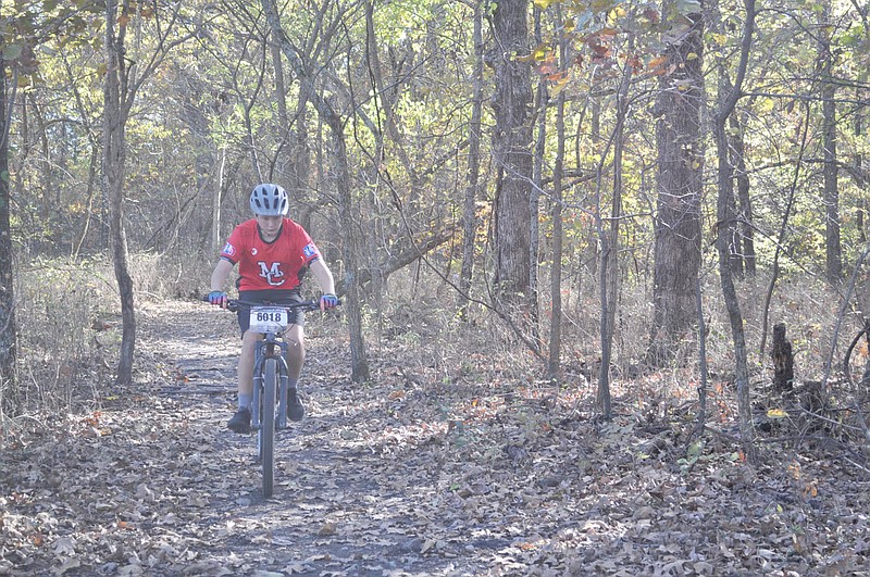 RACHEL DICKERSON/MCDONALD COUNTY PRESS Hayden Lett of the McDonald County Mountain Bike Team makes his way along a three-mile loop on a new mountain bike trail at Morse Park in Neosho. The team practiced at the park on Saturday.