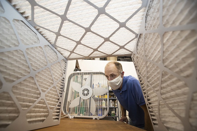 Tom Avril checks out the inside of a box made from furnace filters.
(TNS/Charles Fox/The Philadelphia Inquirer)