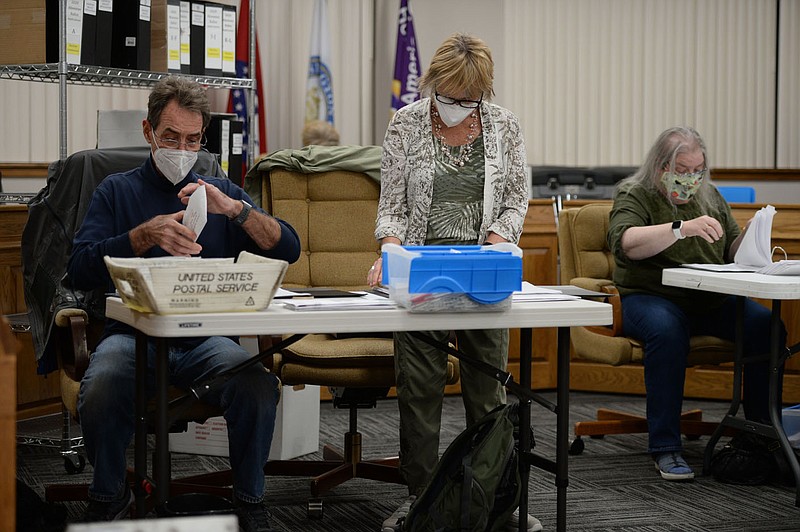 Poll workers tabulate absentee ballots Tuesday, Nov. 3, 2020, at the Washington County Courthouse in Fayetteville. Visit nwaonline.com/201104Daily/ for today's photo gallery. 
(NWA Democrat-Gazette/Andy Shupe)