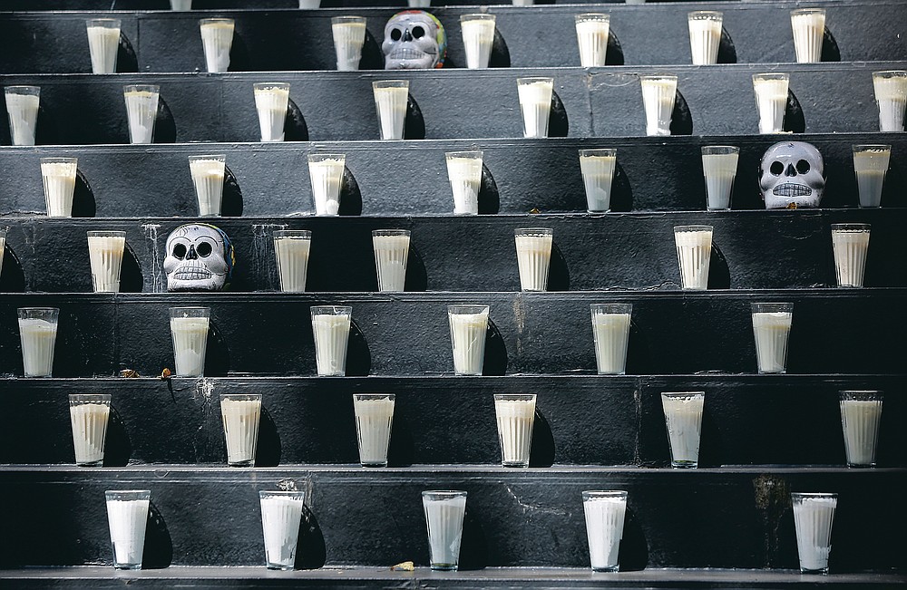 A Day of the Dead altar adorned with candles and skulls sits inside Senate in Mexico City, Saturday, Oct. 31, 2020. Mexico’s Day of the Dead celebration won’t be the same in a year so marked by death after more than 90,000 people have died of COVID-19. (AP Photo/Ginnette Riquelme)