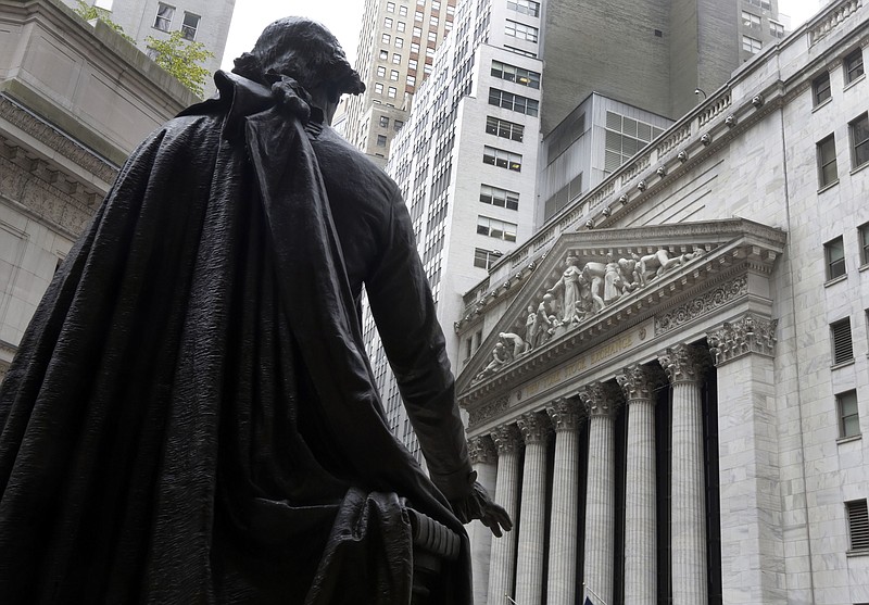 FILE - In this Oct. 2, 2014, file photo, a statue of President George Washington on the steps of Federal Hall faces the facade of the New York Stock Exchange.  U.S. stock futures and markets around the world are mostly holding steady or ticking higher early Wednesday, Nov. 4, 2020, but that’s only after they spun through another election night dominated by surprises and sharp swings.  (AP Photo/Richard Drew, File)