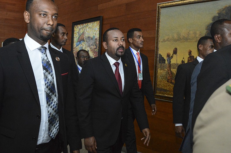 In this Sunday, Feb. 9, 2020, file photo, Ethiopia's Prime Minister Abiy Ahmed, center, arrives for the opening session of the 33rd African Union (AU) Summit at the AU headquarters in Addis Ababa, Ethiopia. Ethiopia's prime minister on Wednesday, Nov. 4, 2020 ordered the military to confront the Tigray regional government after he said it attacked a military base overnight, citing months of "provocation and incitement" and declaring that "the last red line has been crossed." (AP Photo, File)