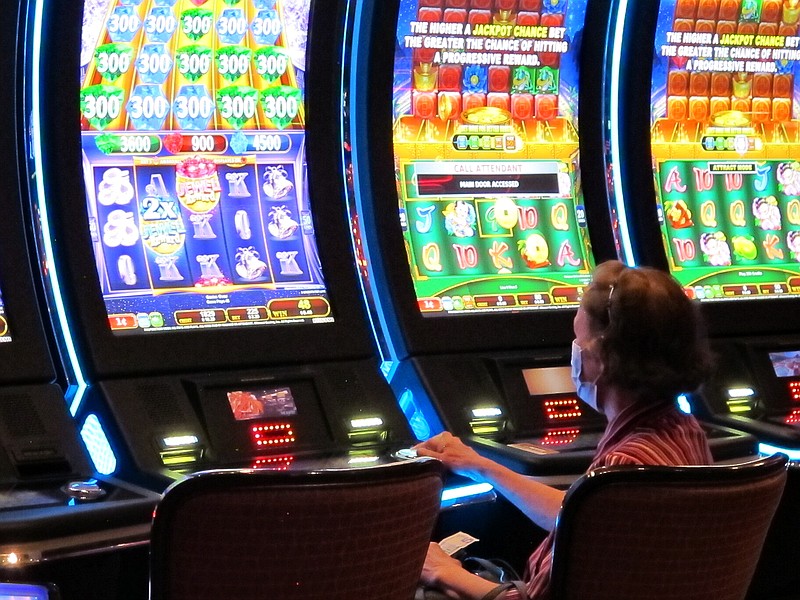 A woman plays a slot machine at the Golden Nugget casino in Atlantic City, N.J. on July 2, 2020. The U.S. gambling industry was a big winner at the polls on Nov. 3, 2020, with three states authorizing sports betting and three others either authorizing or expanding casino gambling. (AP Photo/Wayne Parry)