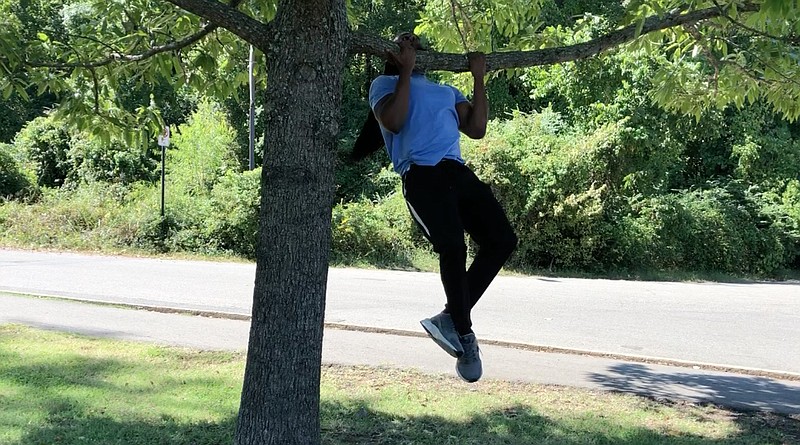 Emmanuel Eyiuche does Jumping Chin-Ups at River Mountain Park. (Arkansas Democrat-Gazette/Celia Storey)