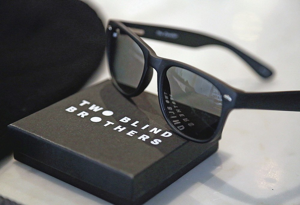 A pair of Two Blind Brothers sunglasses rest on a counter in the Manning brother's New York City loft, on Friday, Oct. 23, 2020. (AP Photo/Jessie Wardarski)