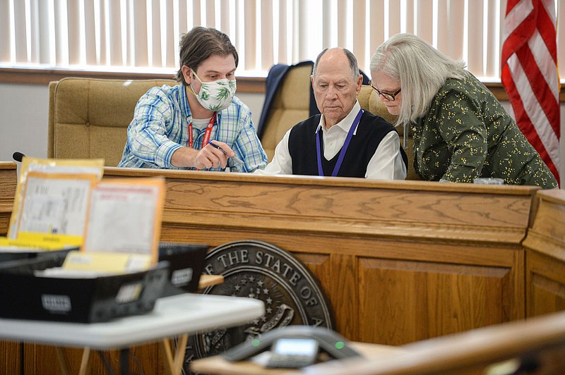 Max Deitchler (from left) and Bill Ackerman, both members of the Washington County Election Commission, work Thursday Nov. 5, 2020, with Renee Oelschlaeger commission chairman as they discuss absentee ballots that arrived with problematic signatures during a meeting of the commission in the Washington County Courthouse in Fayetteville.
(NWA Democrat-Gazette/Andy Shupe)