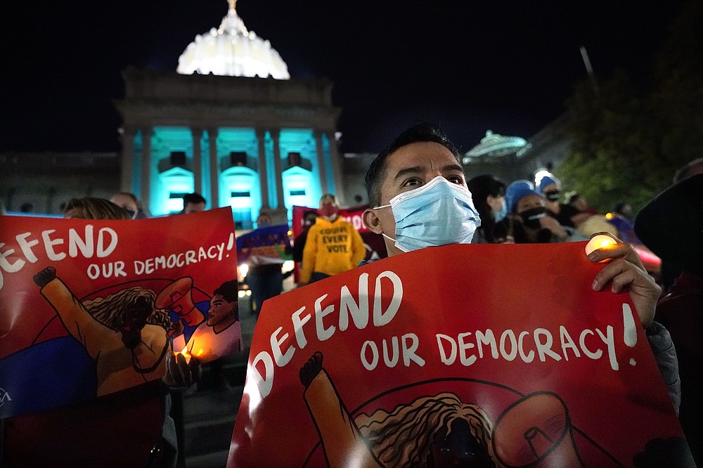 Hector Lugatero, of York, Pa., an Immigrant from Michoacan, Mexico, demonstrates outside the Pennsylvania State Capitol to urge that all votes be counted, Thursday, Nov. 5, 2020, in Harrisburg, Pa., following Tuesday's election. (AP Photo/Julio Cortez)