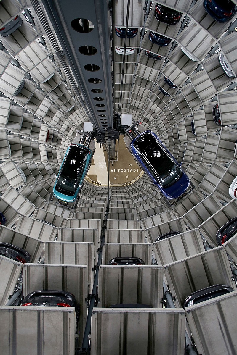 A new Volkswagen AG (VW) ID.3, left, and ID.4, right, electric automobile inside one of the automaker's Autostadt delivery towers at the VW headquarters in Wolfsburg, Germany, on Monday, Oct. 26, 2020. VW reports third quarter earnings on Oct 29. Photographer: Liesa Johannssen-Koppitz/Bloomberg