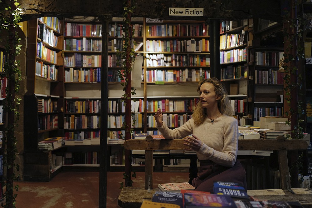 Sylvia Whitman, proprietor of the English and American literature Shakespeare and Co. bookstore, attends an interview in Paris, France, Thursday, Nov. 05, 2020. Iconic Parisian bookshop Shakespeare and Co. has launched a support appeal to its readers after its owners say that coronavirus-linked losses, and a crippling months-long lockdown, have left the future of the veritable institution in doubt. "We've been minus 80 percent since the first confinement in March, so at this point we've used all our savings," Sylvia Whitman, daughter of the shop's co-founder George Whitman, told the Associated Press. (AP Photo/Francois Mori)
