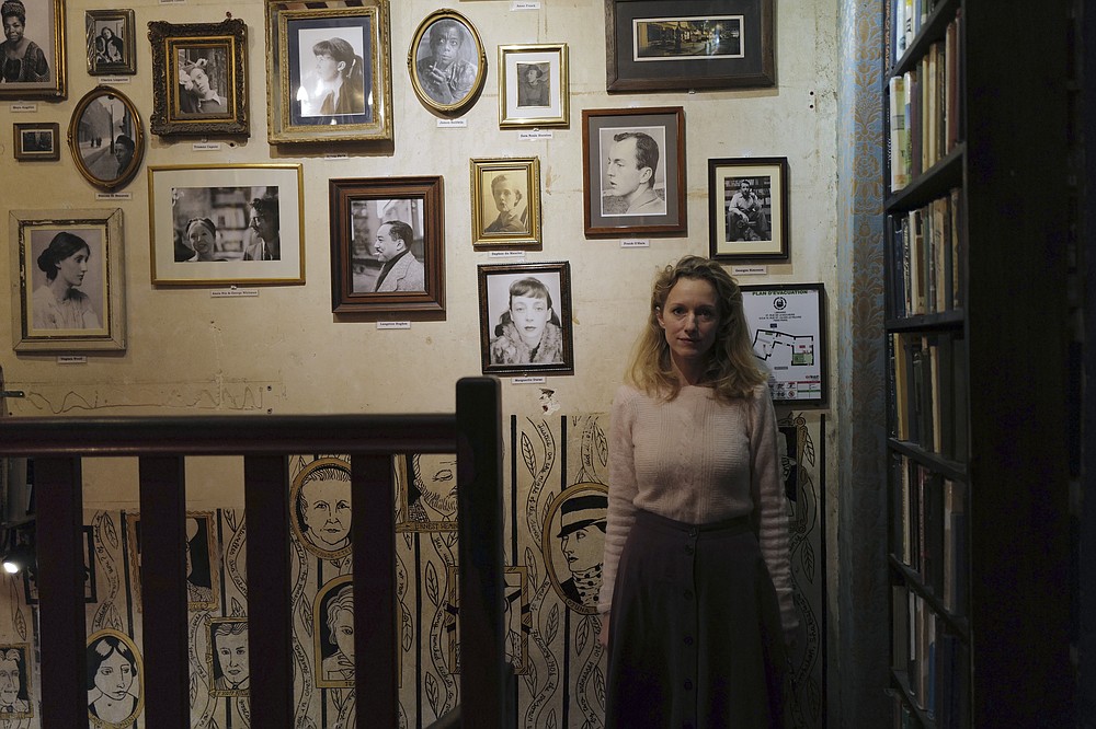 Sylvia Whitman, proprietor of the English and American literature Shakespeare and Co. bookstore, posesin her shop in Paris, France, Thursday, Nov. 05, 2020. Iconic Parisian bookshop Shakespeare and Co. has launched a support appeal to its readers after its owners say that coronavirus-linked losses, and a crippling months-long lockdown, have left the future of the veritable institution in doubt. "We've been minus 80 percent since the first confinement in March, so at this point we've used all our savings," Sylvia Whitman, daughter of the shop's co-founder George Whitman, told the Associated Press. (AP Photo/Francois Mori)
