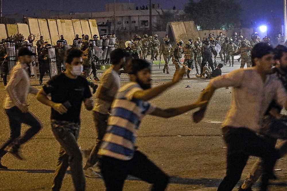 Security forces prevent anti-government protesters from setting up sit in tents in Basra, Iraq, Friday, Nov. 6, 2020. (AP Photo/Nabil al-Jurani}