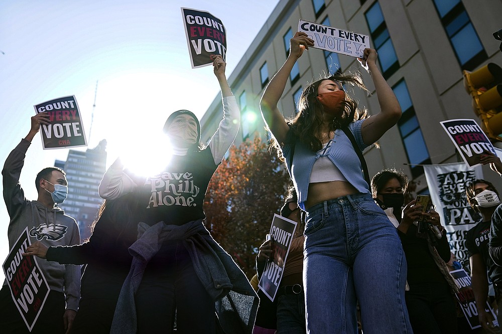 Demonstrators urging all votes be counted gather outside the Pennsylvania Convention Center where votes are being counted, Friday, Nov. 6, 2020, in Philadelphia. (AP Photo/John Minchillo)