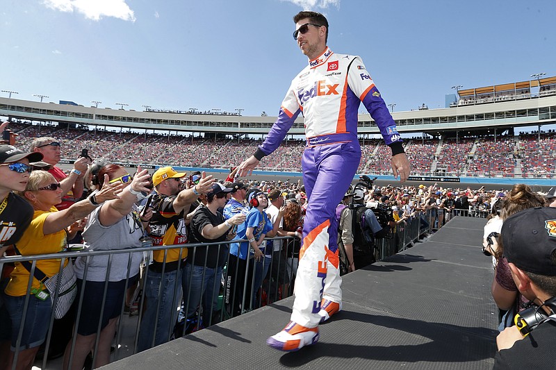 FILE- In this March 8, 2020, file photo, Denny Hamlin walks out during driver introductions prior to the NASCAR Cup Series auto race at Phoenix Raceway in Avondale, Ariz. Hamlin is 0-for-3 in championship chances, his shot at an elusive first NASCAR crown ending just short of the finish line all three times he’s been close. It’s his turn again, without rival Kevin Harvick in his way in Sunday's season finale at Phoenix Raceway. (AP Photo/Ralph Freso, File)