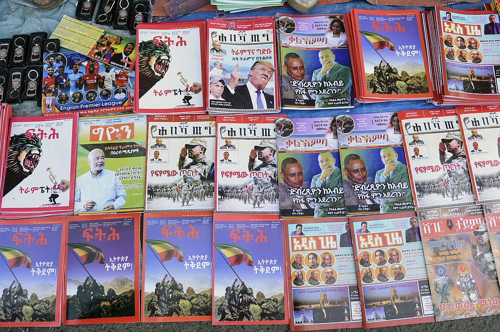 Newspapers and magazines reporting on the current military confrontation in the country are seen at a news stand on a street in the capital Addis Ababa, Ethiopia Saturday, Nov. 7, 2020. Ethiopia moved Saturday to replace the leadership of the country's defiant northern Tigray region, where deadly clashes between regional and federal government forces are fueling fears the major African power is sliding into civil war. (AP Photo/Samuel Habtab)
