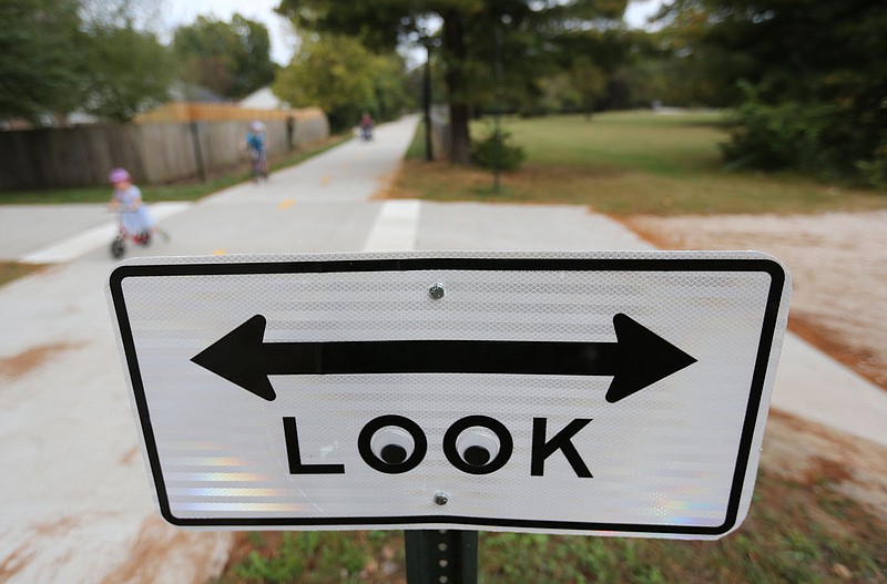 Signage before a private drive is visible Thursday, October 8, 2020, on a new section of trail just south of Sweetbriar Park in Fayetteville. A number of projects related to parks and trails in the city are continuing despite operational budget cuts because of the covid-19 pandemic. Niokaska Creek Trail was unveiled to the public Monday, and stretches from Gulley Park to Sweetbriar Park and connects to Mud Creek Trail to the north. Check out nwaonline.com/201011Daily/ and nwadg.com/photos for a photo gallery.(NWA Democrat-Gazette/David Gottschalk)