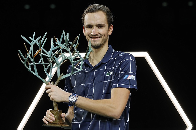 Russia's Daniil Medvedev holds his trophy after the Paris Masters tennis tournament final, Sunday, Nov. 8, 2020 in Paris. Daniil Medvedev won the Paris Masters for the first time by beating Germany's Alexander Zverev 5-7, 6-4, 6-1 on Sunday for his eighth career title and third at a Masters event. (AP Photo/Christophe Ena)