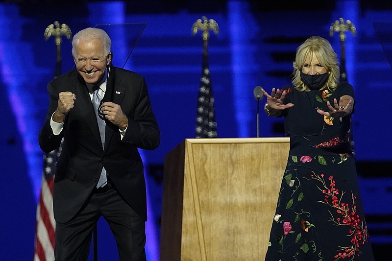 President-elect Joe Biden and wife Jill Biden gesture to supporters Saturday, Nov. 7, 2020, in Wilmington, Del. (AP Photo/Andrew Harnik, Pool)