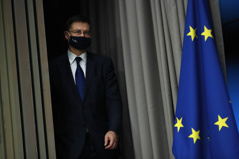 European Commission Vice-President Valdis Dombrovskis arrives for a media conference after a meeting of EU trade ministers, in videoconference format, at the European Council building in Brussels, Monday, Nov. 9, 2020. European Union trade ministers on Monday exchanged views on the trade policy review and relations with China and the United States. (AP Photo/Francisco Seco, Pool)