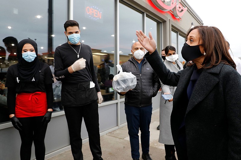 Sen. Kamala Harris, D-Calif., then the Democratic vice presidential nominee, speaks with restaurant employees after making a stop to pick up food at Khalaf Grill on Oct. 25 in Dearborn, Mich.
(Jeff Kowalsky/AFP via Getty Images/TNS)