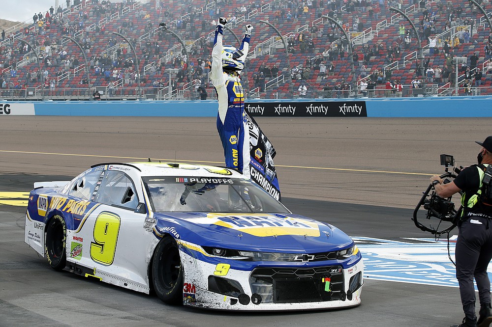 Chase Elliott stands on his race car to acknowledge the fans after winning the season championship and the NASCAR Cup Series auto race at Phoenix Raceway, Sunday, Nov. 8, 2020, in Avondale, Ariz. (AP Photo/Ralph Freso)