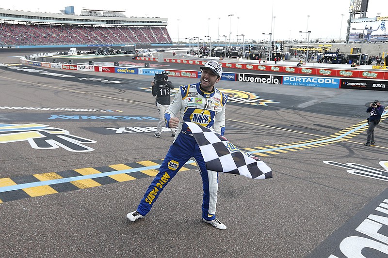 Chase Elliott celebrates at the finish line after winning the season championship and a NASCAR Cup Series auto race at Phoenix Raceway, Sunday, Nov. 8, 2020, in Avondale, Ariz. (AP Photo/Ralph Freso)