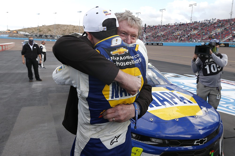 Chase Elliott hugs his father Bill Elliott after winning the season championship during a NASCAR Cup Series auto race at Phoenix Raceway, Sunday, Nov. 8, 2020, in Avondale, Ariz. Bill is also a former series champion. (AP Photo/Ralph Freso)