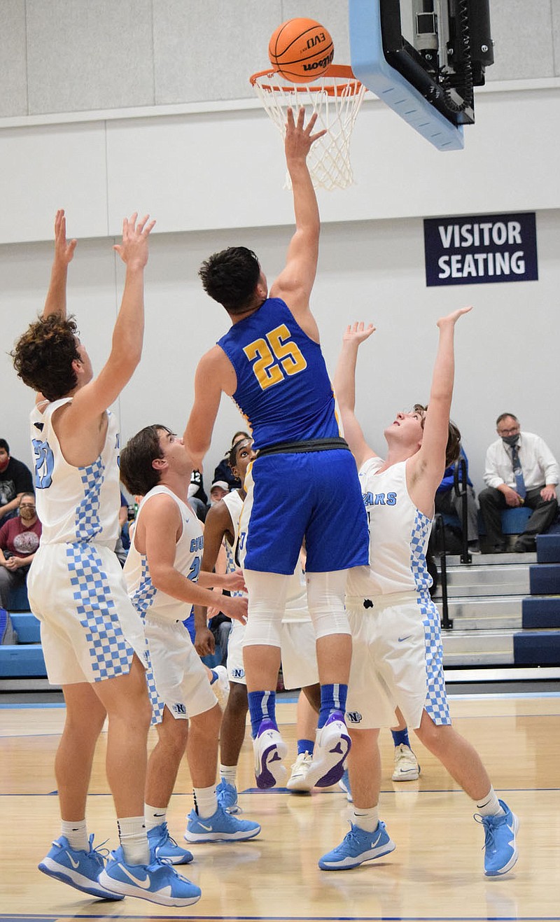 Westside Eagle Oberserver/MIKE ECKELS

In spite of a pack of Cougar defenders, Bulldog Kevin Garcia (25) gets serious air time as he goes for a layup during the Nov. 9 New School-Decatur basketball contest in Fayetteville. Garcia accounted for 10 or the Bulldogs 32 points for the night.