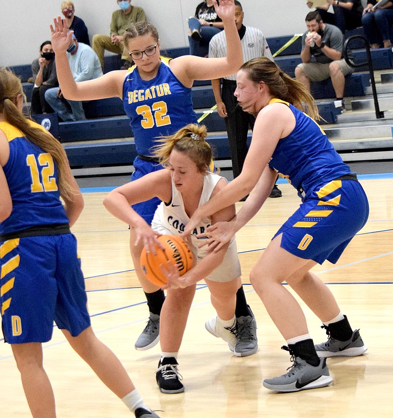 Westside Eagle Observer/MIKE ECKELS

While Annabelle Bell (Decatur 32) blocks a possible escape route, Annabelle Schopper (right) tries to steal the ball away from a Lady Cougar player during the Nov. 9 New School-Decatur girls basketball contest in the New School gym in Fayetteville..