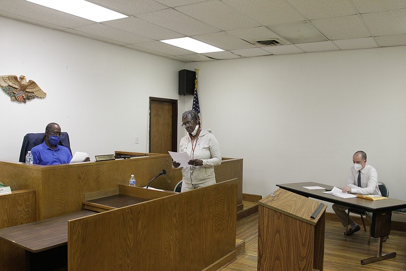 As Gould Mayor Matthew Smith, left, and City Attorney Clint Todd, right, listen, Recorder/Treasurer Sheila Smith reads the minutes from last month's Gould City Council meeting. (Pine Bluff Commercial/Dale Ellis)