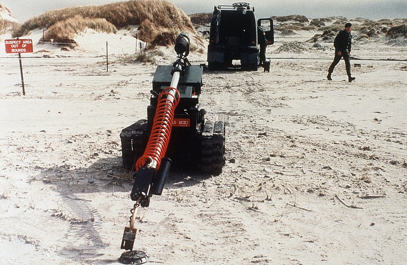 FILE - In this Dec. 10, 1985 file photo, “Redfire,” a remote-controlled robot, undergoes testing in a mine clearance operation by British army troops in the Falkland Islands. Britain’s Foreign Office has on Tuesday, Nov. 10, 2020 the Falklands will soon be landmine free - almost 40 years after the end of the conflict. The U.K. funded program, which started in 2009, is set to end three years ahead of schedule. With the completion of the program, no anti-personnel mines will remain on British soil. (AP Photo/John Leonard, file)