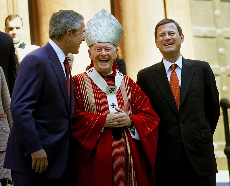 FILE - In this Oct. 2, 2005 file photo, President Bush, left, laughs with Cardinal Theodore E. McCarrick Archbishop of Washington, D.C., center, and Chief Justice of the United States John Roberts, right, as they walk out of St. Matthew's Cathedral after attending the 52th Annual Red Mass in Washington. The Red Mass is held on the Sunday prior to the opening of the Supreme Court's session. (AP Photo/Pablo Martinez Monsivais, File)