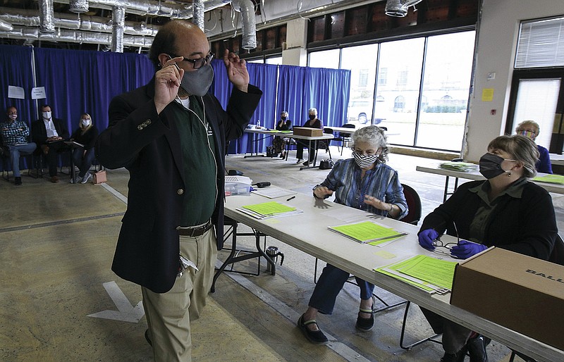 Bryan Poe, left, Director of Elections, instructs election officials to continue counting ballots Tuesday Nov. 10, 2020 in Little Rock at the Pulaski County election Commission during the tabulation of provisional ballots cast during the November 3, 2020 General Election.
 (Arkansas Democrat-Gazette/Staton Breidenthal)