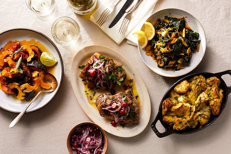 Tiny is the new big this holiday season, and making a small meal can be just as festive — and a whole lot easier — than a feast. Clockwise from left, Maple-Roasted Squash With Sage and Lime, Sauteed Greens With Smoked Paprika, Herby Bread-and-Butter Stuffing and Turkey Thighs With Pickled Cranberries and Onions 
(The New York Times/Christopher Simpson)