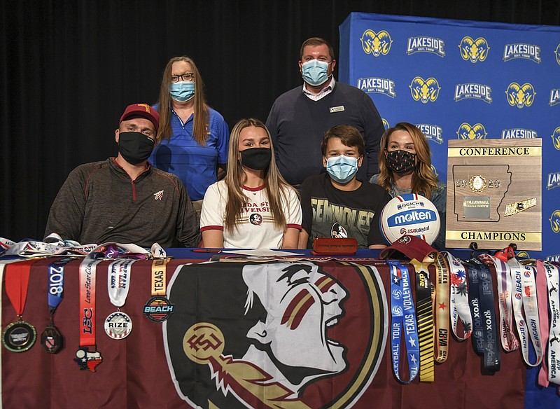 Lakeside senior Maddie Trusty, center, is joined by, from left, her father Landon, Lakeside volleyball coach Rhonda Thigpen, principal Darin Landry, brother Sam and mother Erica as she signs a letter of intent to play beach volleyball with Florida State University Wednesday. - Photo by Grace Brown of The Sentinel-Record