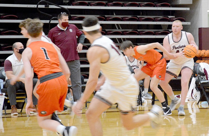 Graham Thomas/Siloam Sunday
Siloam Springs senior Jackson Ford, right, looks to pass up the floor during a fast break in the Panthers' benefit game against Gravette on Tuesday at Panther Activity Center. The Panthers defeated the Lions 72-48.