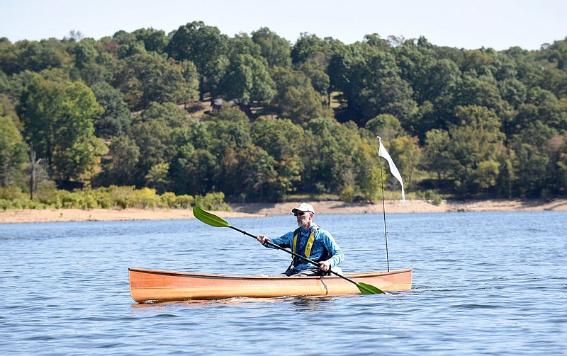 Tony Eliasen of Bentonville paddles along Beaver Lake on the first day, Oct. 2 2020, of his 120-mile canoe adventure from the U.S. 412 bridge on Beaver Lake to downtown Branson. Eliasen figures he did about 20,000 paddle strokes each day of the journey. 
(NWA Democrat-Gazette/Flip Putthoff)