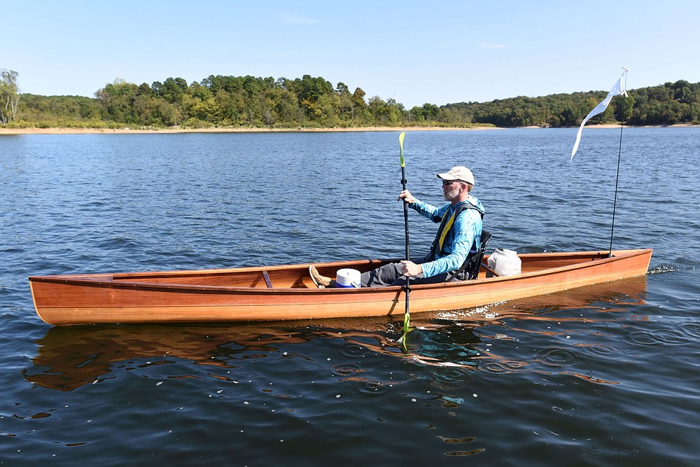 Tony Eliasen paddles near Horseshoe Bend Park on Beaver Lake during the first day, Oct. 2 2020, of his 120-mile canoe trip from the U.S. 412 bridge to downtown Branson.
(NWA Democrat-Gazette/Flip Putthoff)