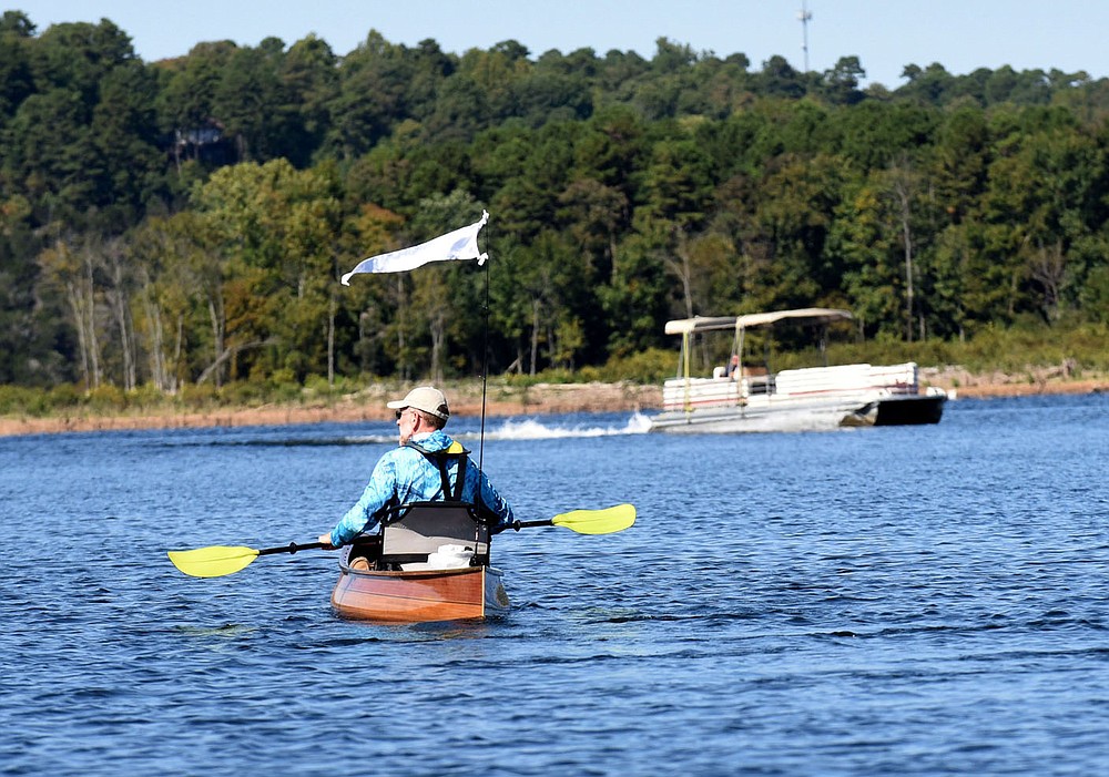 A flag on his canoe's stern increased Elisen's visibility to approaching power boats.
(NWA Democrat-Gazette/Flip Putthoff)