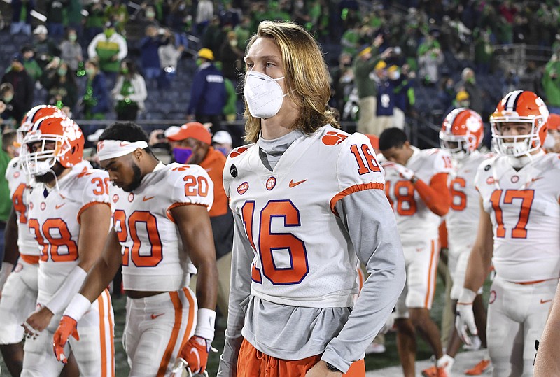 Clemson quarterback Trevor Lawrence (16) leaves the field with his teammates after Clemson lost to Notre Dame 47-40 in two overtimes during Saturday's game in South Bend, Ind. As virus disruptions mount and the Dec. 19 end of college football's regular season draws closer, the possibility grows that conference championships, major awards and even College Football Playoff participants will be determined by COVID-19. - Photo by Matt Cashore/Pool Photo via The Associated Press