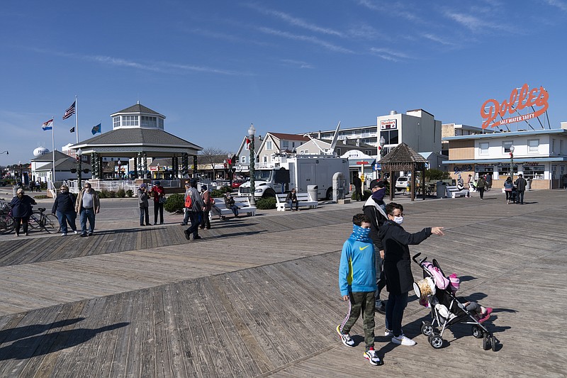 People enjoy the boardwalk, Friday, Nov. 13, 2020, in Rehoboth Beach, Del. This resort town known for Atlantic waves that are sometimes surfable, fresh-cut French fries and a 1-mile wooden boardwalk that dates back to the 1870s has long prided itself on being the “Nation's Summer Capital.” - AP Photo/Alex Brandon story.lead_photo.caption