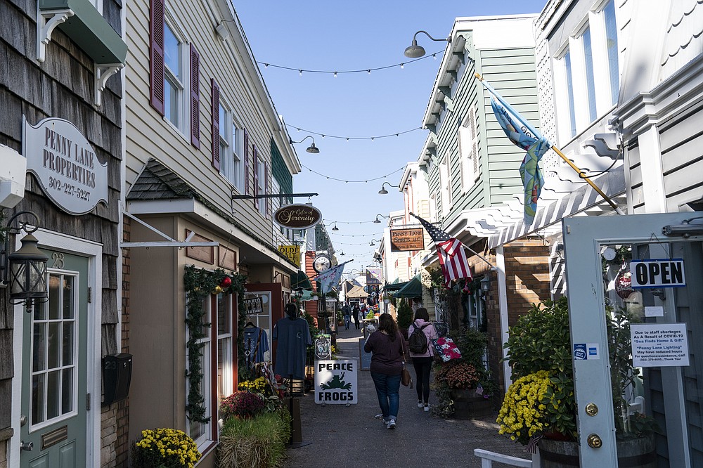 Shops are open, Friday, Nov. 13, 2020, in Rehoboth Beach, Del. President-elect Joe Biden owns a $2.7 million, Delaware North Shores home with a swimming pool that overlooks Cape Henlopen State Park, is blocks from the ocean and a short drive from downtown Rehoboth Beach.(AP Photo/Alex Brandon)