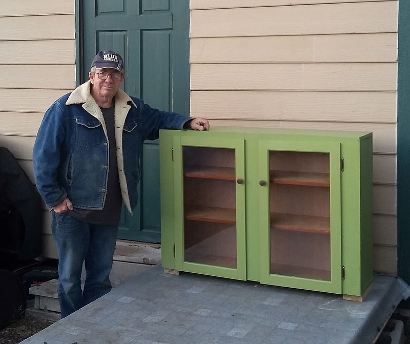 SALLY CARROLL/SPECIAL TO MCDONALD COUNTY PRESS Gary Henretty shows off the renovated cabinet that he turned into a new "Blessing Box" for Noel. He and his wife, Diana, hope the Blessing Box, just placed at Noel City Hall, will help those down on their luck or in need of a few items. The effort is a community-wide one. The Henretty's stress that anyone can donate goods for the box, and anyone in need can take some goods for free.