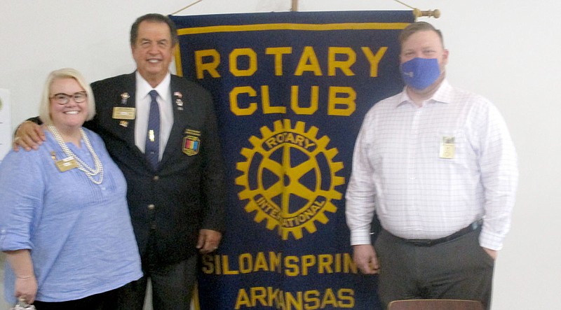 Marc Hayot/Herald-Leader Rotary District 6110 Assistant Governor Johnice Glisson (left), District Governor Jay Craig and Siloam Springs Rotary Club President Tim Davis pose for a photo in front of the club's Rotary Banner. Craig came to the club's meeting on Nov. 10 and spoke about the impact Rotary has had on communities world wide and the need to recruit new Rotarians to continue the projects Rotary undertakes. Projects Craig mentioned included the push to cure Polio and the Wheelchair Drive to provide people in underdeveloped nations with wheelchairs for those who need it.