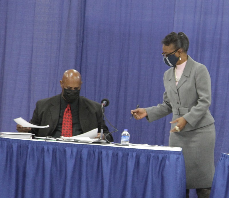 Alderman Steven Mays, left, looks over some papers handed to him by City Clerk Loretta Whitfield prior to Monday night's City Council meeting. Mays was roundly rebuked by other council members over two resolutions he had placed on the agenda without prior notice or consultation with any of the committees that oversee pending legislation. Resolutions, which are nonbinding, do not have to be vetted through committees. (Pine Bluff Commercial/Dale Ellis)