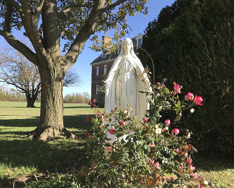 A statue of the Virgin Mary outside St. Francis Xavier Church, with the old Jesuit plantation manor in the background in Newtowne Neck State Park. MUST CREDIT: Washington Post photo by Michael E. Ruane