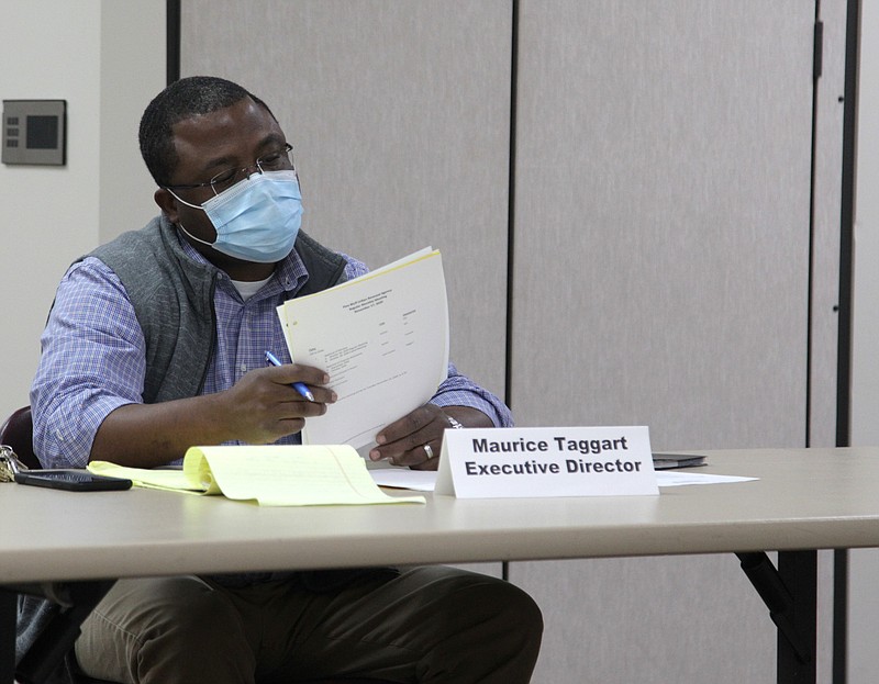 Maurice Taggart, executive director of the Pine Bluff Urban Renewal Agency, reviews documents prior to the agency's regular monthly board meeting Tuesday evening. (Pine Bluff Commercial/Dale Ellis)
